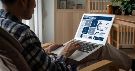 Human resources management software on computer screen helping human resources employee to manage...