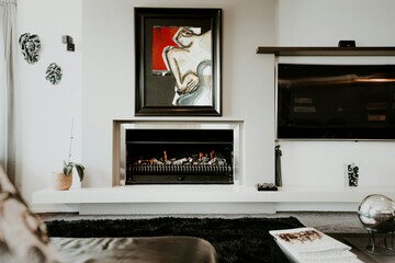 Modern living room with red black and white picture and fireplace in the room