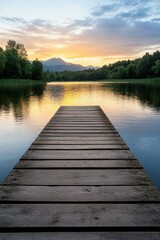 Fototapeta premium Sunset over calm lake from wooden pier surrounded by trees