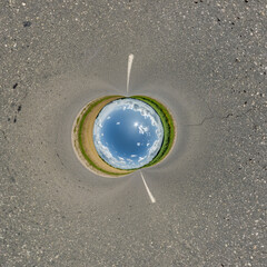blue hole sphere or globe little planet inside green dry grass or stone with sand frame background