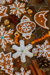christmas baked gingerbread snowflakes cookies with evergreen twigs on wood, color of the year 2025 mocha mousse