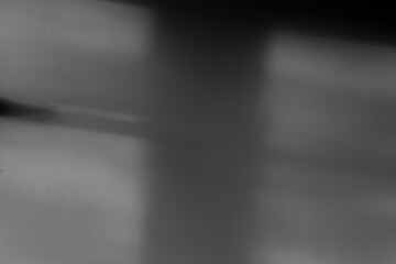Soft, blurred shadows dance across a surface, creating an enigmatic ambiance reminiscent of...