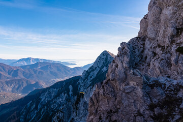 Hiking trail to summit of mount Piper along massive rock formations in Julian Alps, Friuli Venezia...