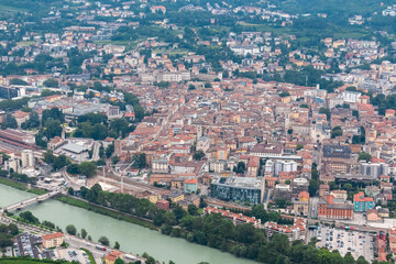 Breathtaking aerial view of city of Trento nestled amidst cloud covered mountainous landscape in Trentino Alto Adige, Italy. Vantage point from Terrazza Panoramica Busa Degli Orsi. Tourist destination