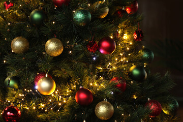 Christmas tree with decorations, fairy lights surrounded by many beautiful colored balls for...