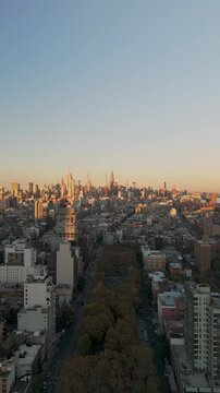 Warm sunlight bathes the bustling Christie street in the Two Bridges neighbourhood of New York City creating an urban landscape across vibrant cityscape in a vertical video