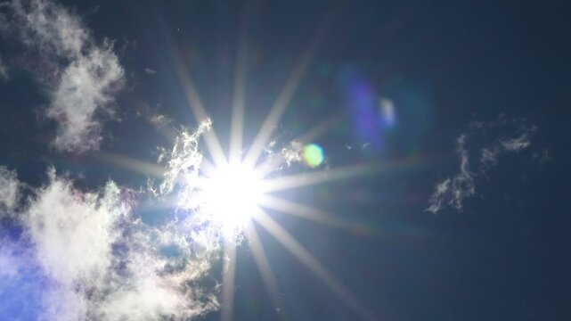  A stunning image of a sunburst breaking through the clouds, creating a dramatic and inspiring scene. The bright light and contrast between the sun and clouds create a visually striking composition.