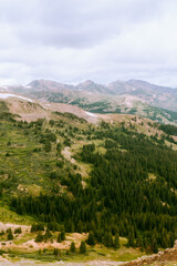 Naklejka premium view on mountain with trees and jagged peak in background