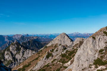 Summit of mount Due Pizzi Cima Alta surrounded by rugged mountain peaks of Dolomites, Carnic Alps and Julian Alps. Hiking trail to mount Piper in Friuli Venezia Giulia, Italy. Wanderlust Italian Alps