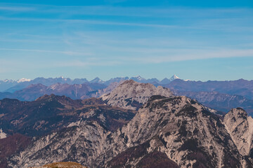 Distant clear view of rugged mountain peak Grossglocker in majestic High Tauern in Austria. Hiking trail to mount Piper in Julian Alps, Friuli Venezia Giulia, Italy. Wanderlust Italian Alps in summer