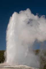 Old Faithful geyser erupting, Yellowstone National Park.