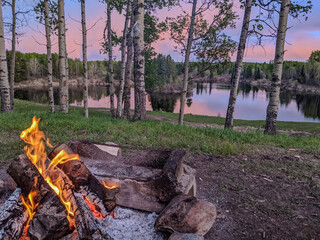 Glowing Campfire with Vibrant Lake Reflection