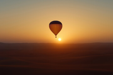 Obraz premium Hot air balloon soaring over desert landscapes during sunrise in soft golden light