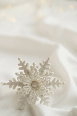 Minimalist Winter Decor: Snowflake on Draped Fabric