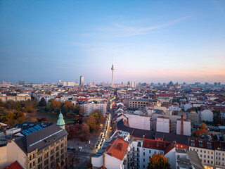 Aerial view of Berlin skyline in Autumn, featuring the iconic Fernsehturm television tower, surrounded by buildings and a park, with the berliner dom visible in the distance