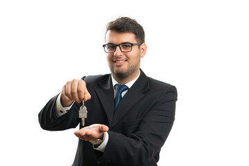 Real estate agent smiling presenting home keys property concept