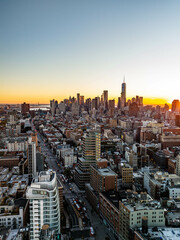 Sunset glows on Financial District of Lower Manhattan, including one world trade center and surrounding buildings of New York City from an elevated viewpoint