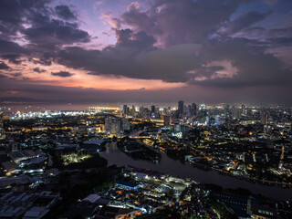 Manila skyline and Pasig River illuminated by a stunning sunset, with enchanting clouds adding a magical touch to the cityscape