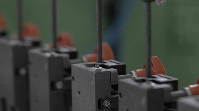 Press for cutting special holes on cardboard material. Rods of mechanism exert pressure on sheets forming necessary product structure