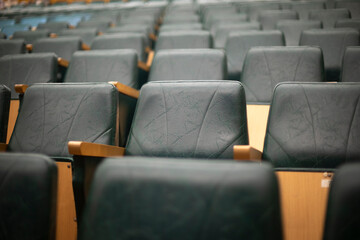 Lot of seats in hall. Empty spaces. Seating area.