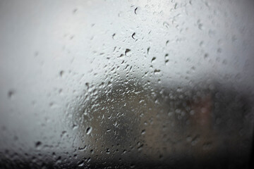 Wet glass. Small drops on the window. Rain outside the window.