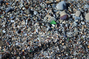 Close-Up of Colorful Pebbles and Glass on Shoreline