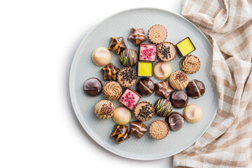 Mix of chocolate pralines on plate isolated on white background.