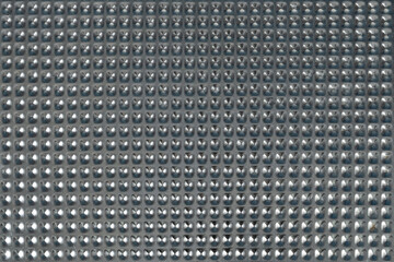 Metallic texture background with horizontal dots, captured in close-up