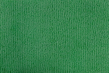 Green fabric texture background with soft and rough weave, close-up