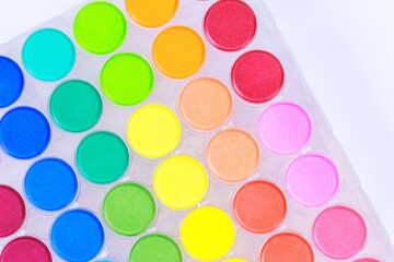 An essential tool for artists hobbyists, this palette of colorful watercolors is arranged in...
