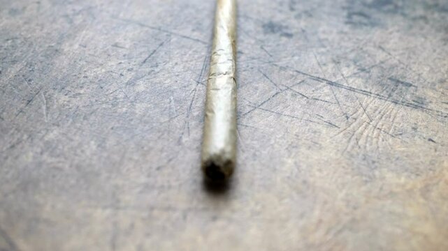 Close up of cannabis joint on grunge background