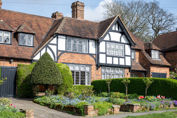 Walking on streets of North London, red brick houses and flowering gardens in spring, city life,...