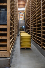 Aging rooms with shelves in cheese caves, central location for aging of wheels, rounds of Comte cheese from four months to several years made from raw cow milk, Jura, France