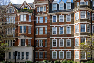 Red bricks houses on Hans Crescent street in Royal Borough of Kensington and Chelsea, London, UK