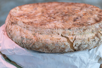 Weekly farmers market in Sarlat-la-Caneda, Dordogne, french cheeses from farm, matured sheep cheese tomme smoked, with Perigord truffles