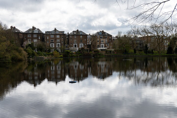 View on urban park Hampstead Heath with ponds, hills and view points, North London, UK