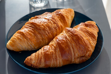 Fresh baked buttered croissants served in restaurant for continental or French breakfast close up