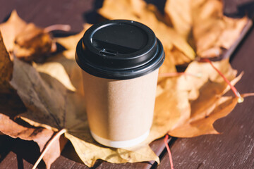 A single coffee cup sits on a wooden table, awaiting its first sip.