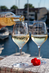 Glasses of cold rose gris Cote de Provence wine in yacht harbour of Port Grimaud, summer vacation on French Riviera in Provence, France, wine tasting