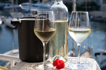 Glasses of cold white Cote de Provence wine in yacht harbour of Port Grimaud, summer vacation on French Riviera in Provence, France, wine tasting