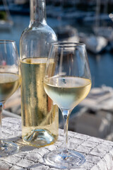 Glasses of cold white Cote de Provence wine in yacht harbour of Port Grimaud, summer vacation on French Riviera in Provence, France, wine tasting
