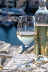 Glasses of cold white Cote de Provence wine in yacht harbour of Port Grimaud, summer vacation on French Riviera in Provence, France, wine tasting