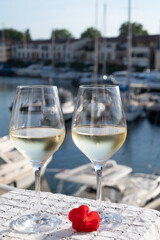Glasses of cold white Cote de Provence wine in yacht harbour of Port Grimaud, summer vacation on French Riviera in Provence, France, wine tasting