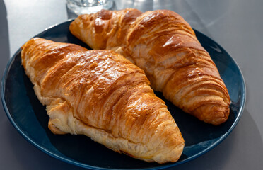 Fresh baked buttered croissants served in restaurant for continental or French breakfast close up