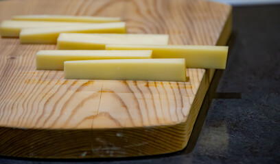 Cheese tasting in aging rooms with shelves in caves, central location for aging of wheels, rounds of Comte cheese from four months to several years made from raw cow milk, Jura, France