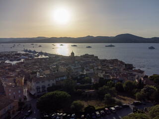 Fototapeta premium Aerial view on bay, hills,, old citadel fort, olorful houses of famous Saint-Tropez town on French Riviera, Var, Provence, France, summer vacation destination