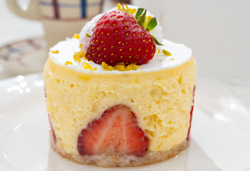 Red fruit sweet dessert cheesecake tart with fresh strawberries in bakery