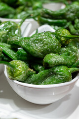 Typical snacks of Basque Country, pinchos or pinxtos skewers with small pieces of bread, fish, sea food, sweet green pepper served in bar in San-Sebastian or Bilbao, Spain