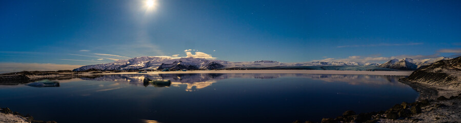 Jokulsarlon lagoon at night in Iceland in winter with moon and stars