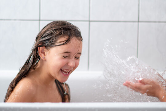 Bath time is fun. cute little girl taking a bath in splashes of water